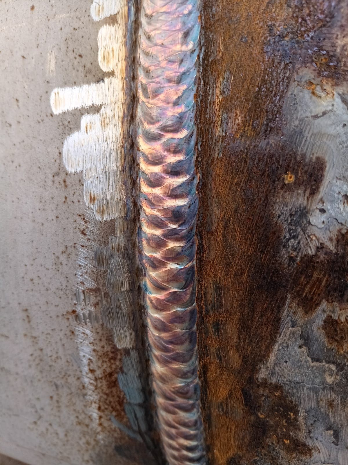 Stacked weld passes on a steel plate